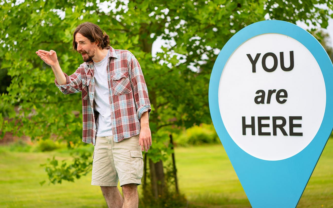 Photo of Harry Egan with You Are Here Sign