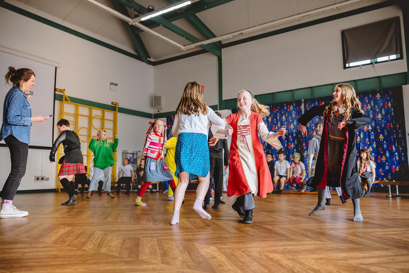 Children practicing a dance in a drama workshop