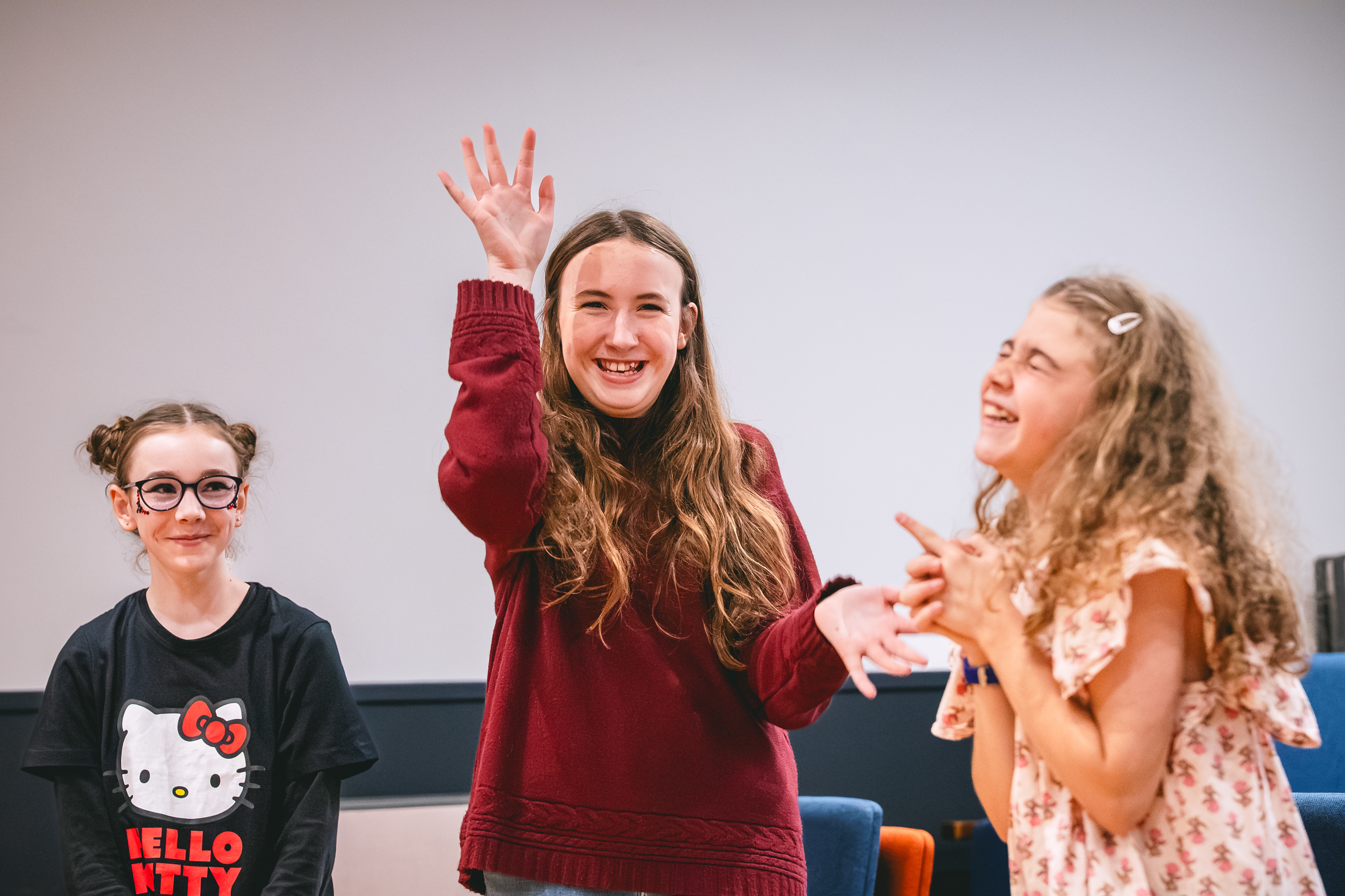 Smiling teenagers in a theatre workshop
